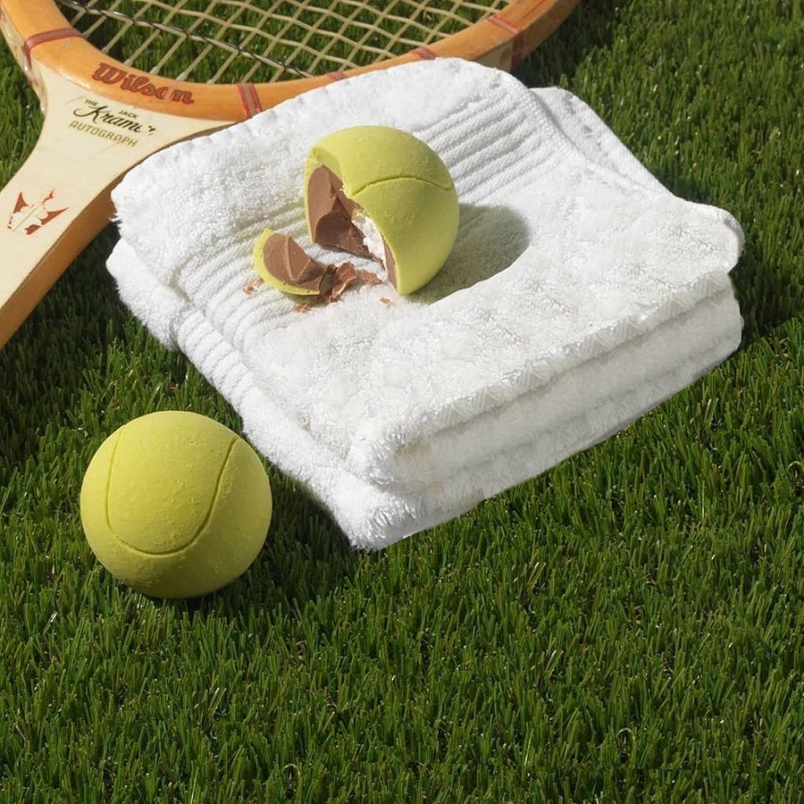 A chocolate tennis ball on a tennis lawn