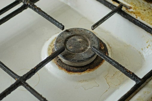 one black dirty round iron gas burner on a burnt metal gas stove to represent an energy supplier going bust