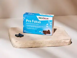 Hellblaue Produktverpackung Pro Fokus auf Steinplatte.