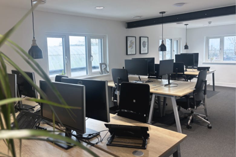 Upstairs workspace, desks full of monitors ready for work