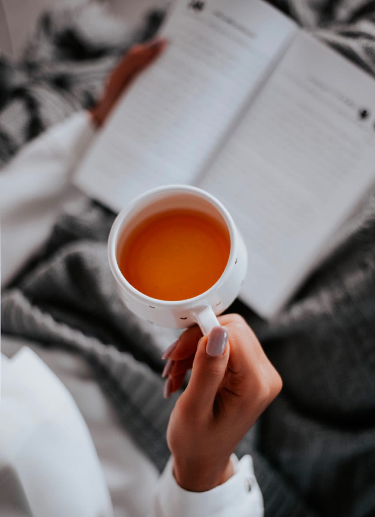 Drinking tea and enjoying a book