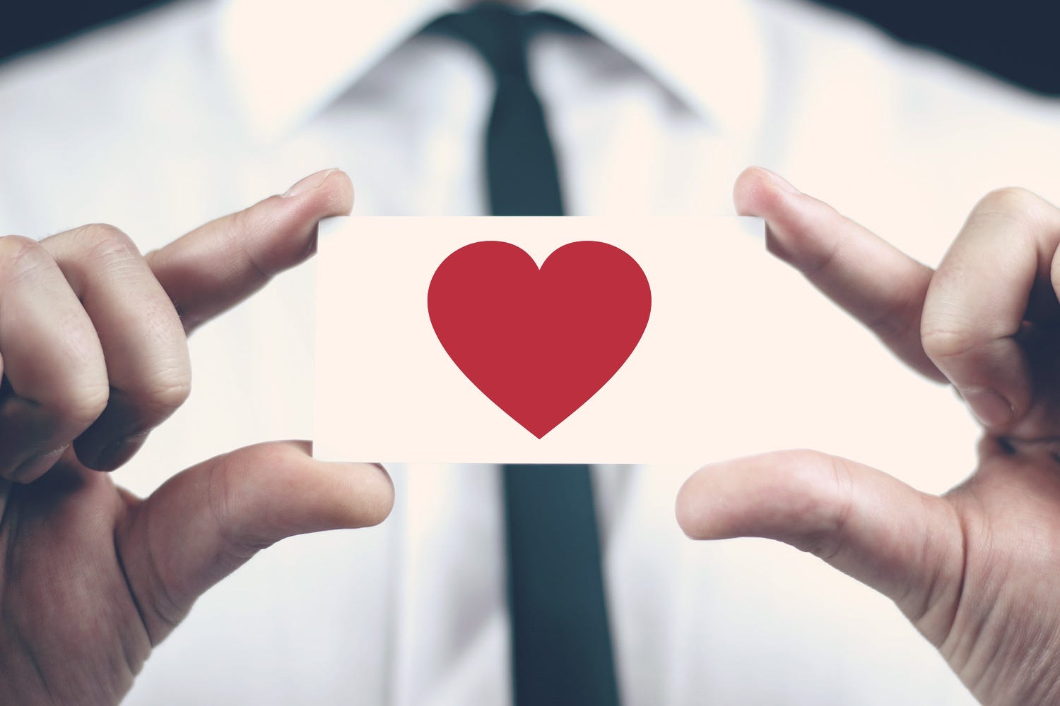 Business man holding love heart