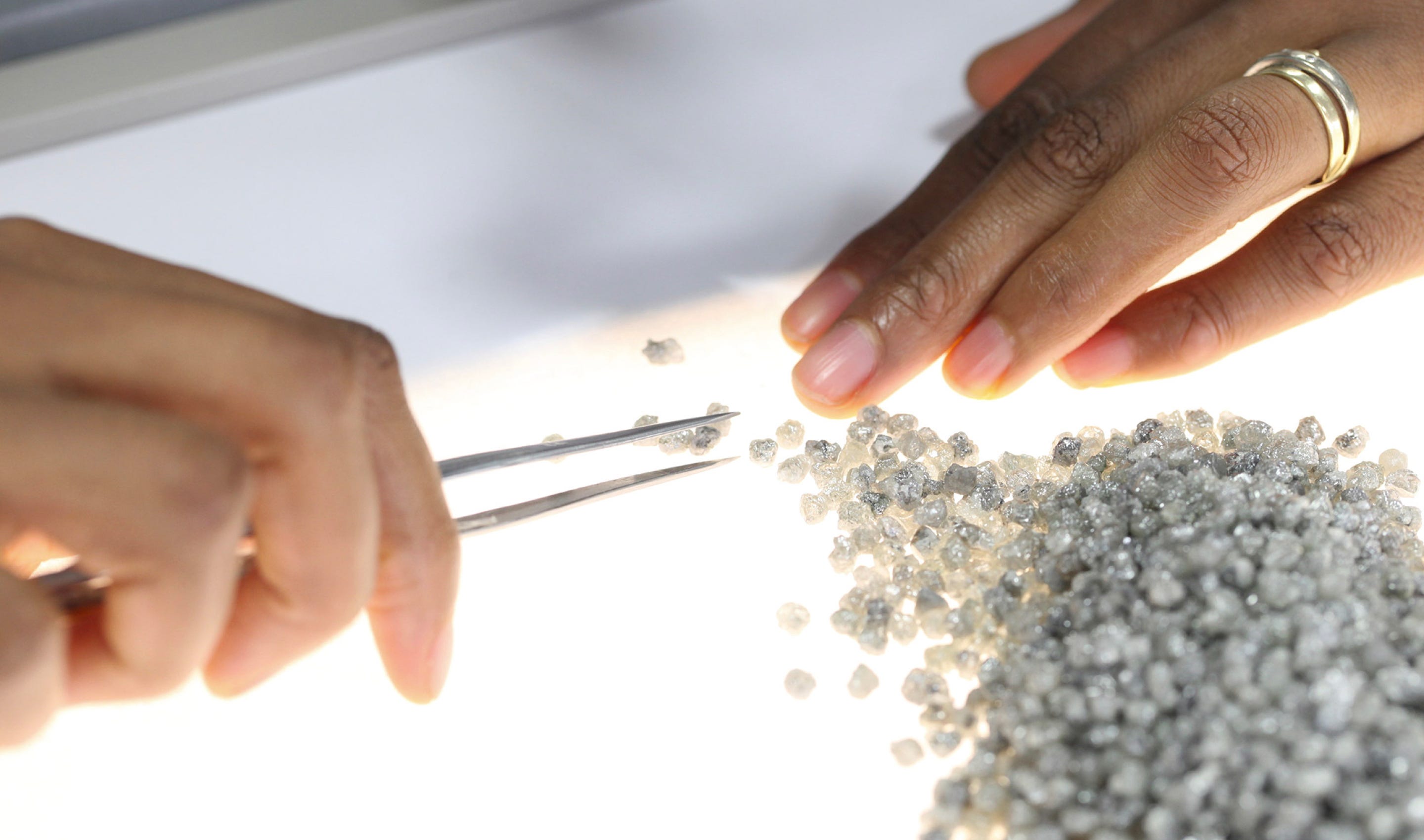 Lady sorting De Beers Diamonds