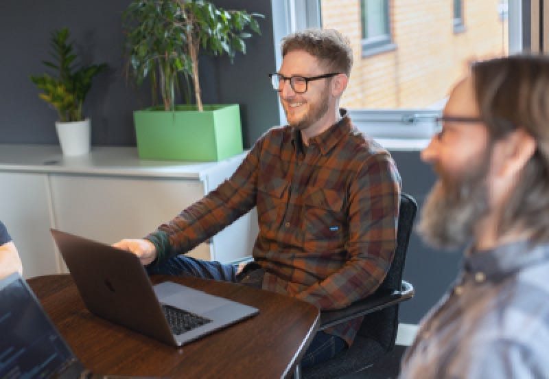 Two colleagues laughing in a meeting