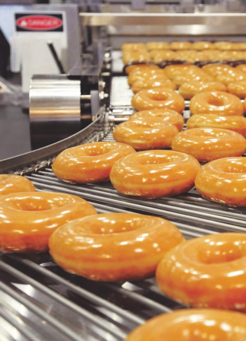 Krispy Kreme doughnuts being glazed