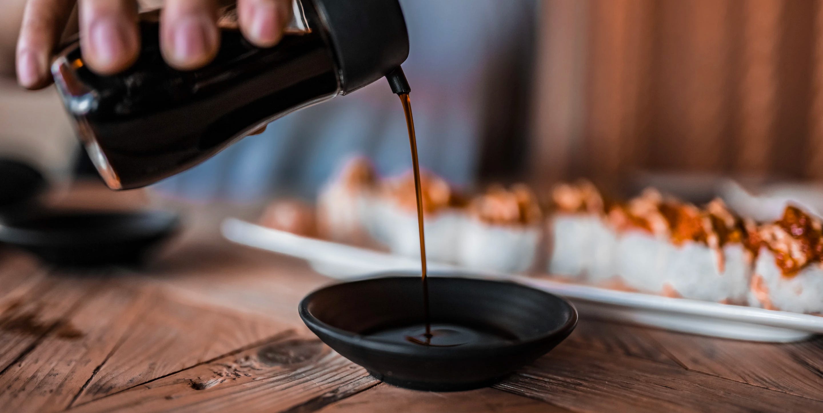 Soy sauce being poured into a dish