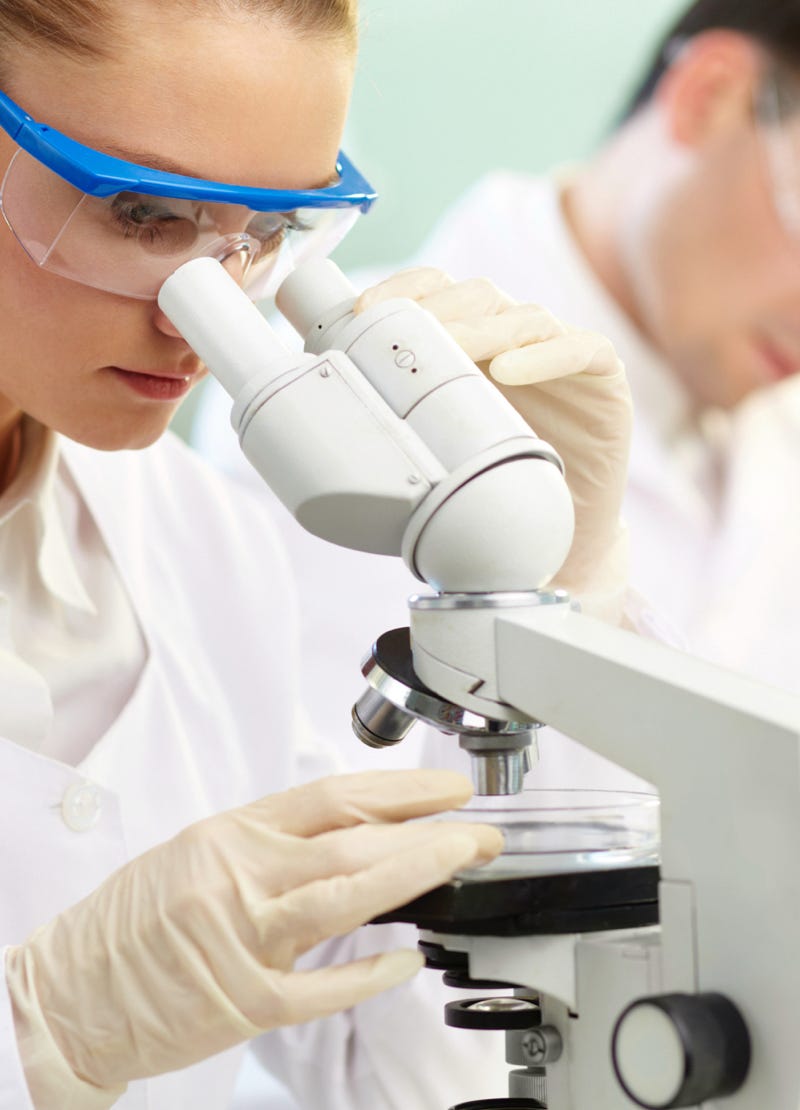 Scientist looking through a microscope