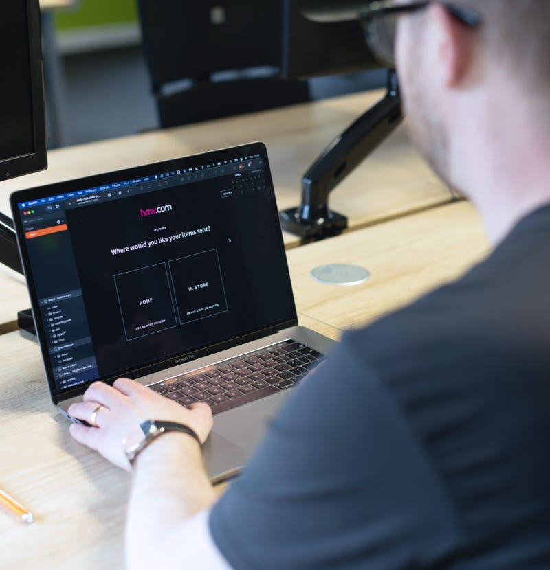 A man designing a page for the hmv brand