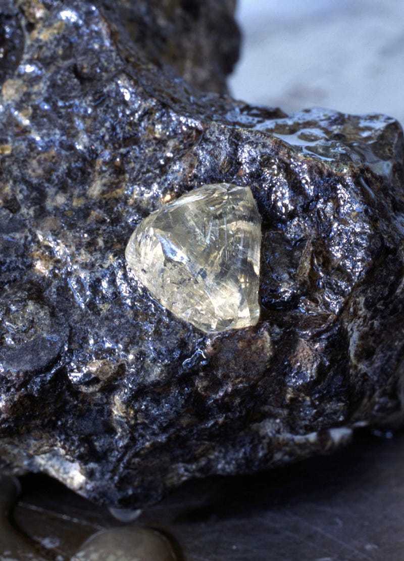 De Beers rough diamonds within rocks