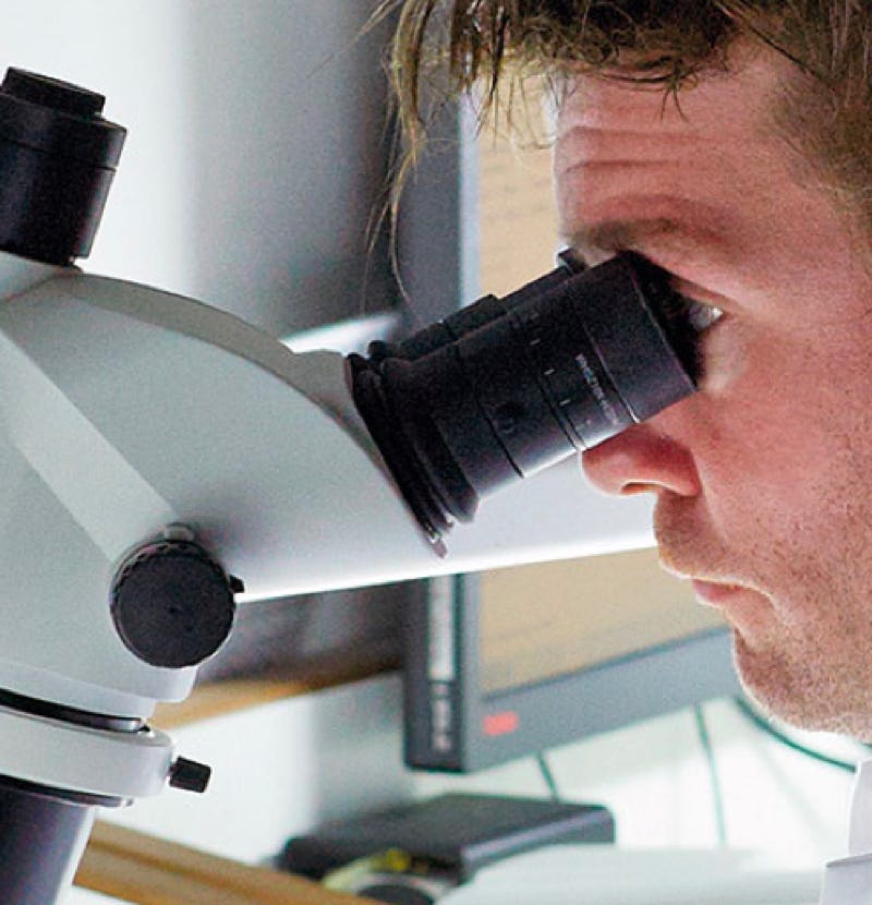 De Beers scientist looking into a microscope
