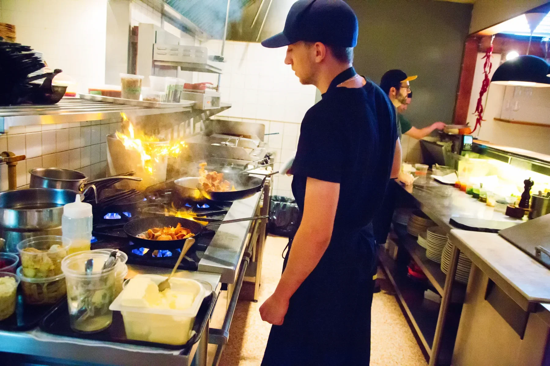 A chef cooks on a gas cooker in a restaurant kitchen