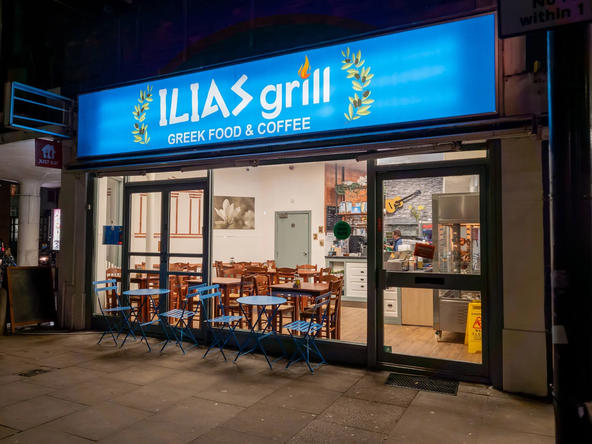 The front of a Greek restaurant in London. The late opening hours mean it may benefit from a time-of-use energy tariff.