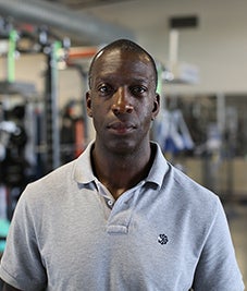 Former Olympic runner Michael Johnson looks into the camera.