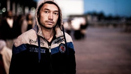 A picture of a man wearing a hooded jacket