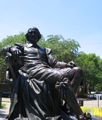 A picture of a Shakespeare statue. It presents him seated.