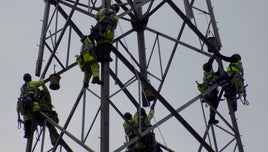 Engineers work on pylon on OU/BBC series Power to the People
