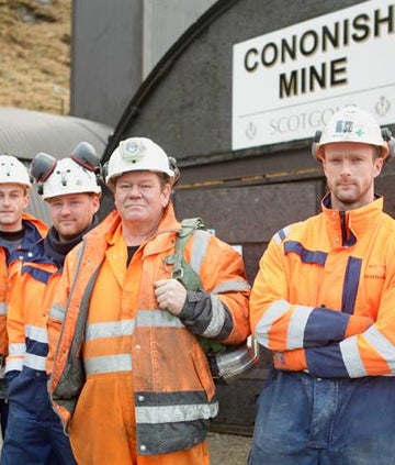 7 men stood outside of Cononish Mine
