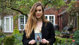 A picture of Charlie holding a photograph of herself from when she was in school.