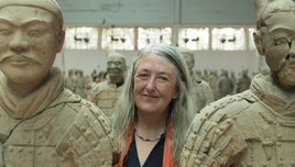 Mary Beard standing among Terracotta Army statues