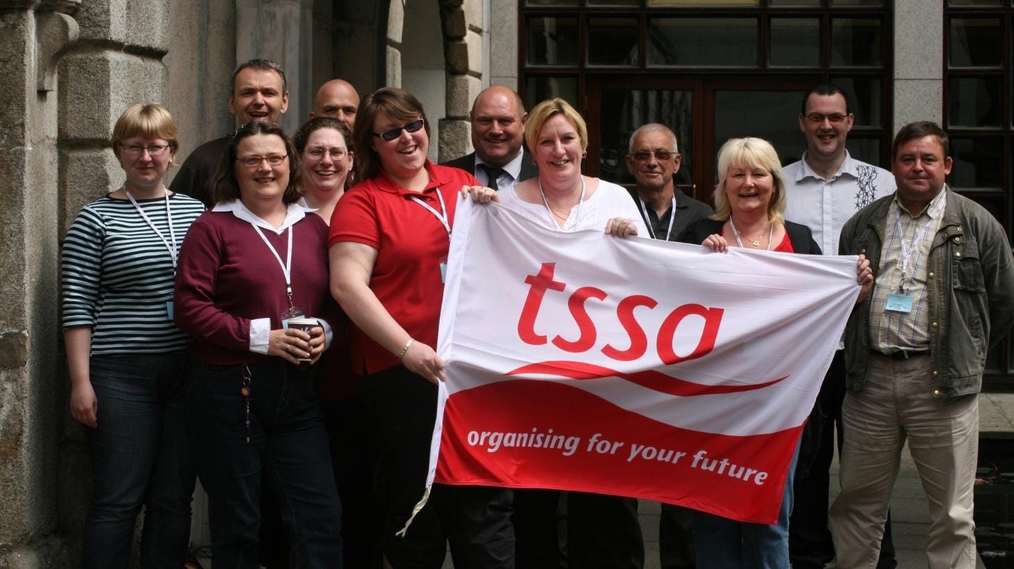TSSA reps holding a TSSA logo flag