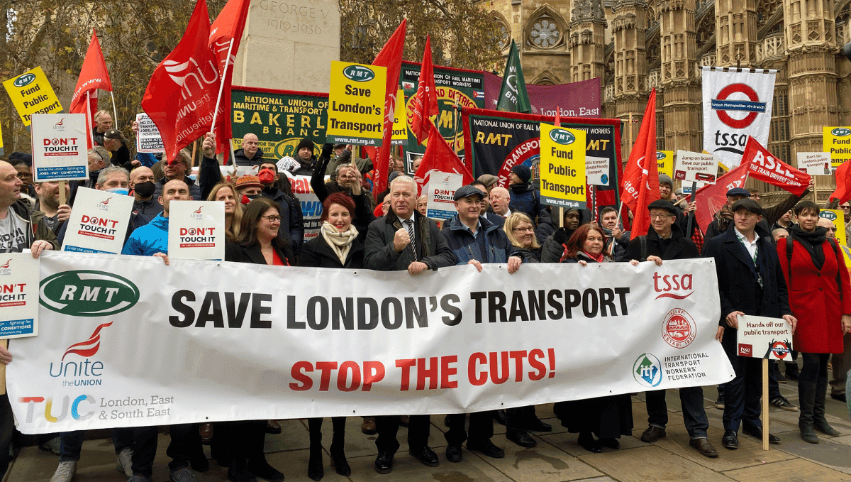 Save London Public Transport demonstration with banners, flags, MPs