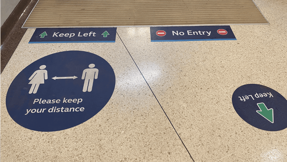 Social distancing signs on station floor