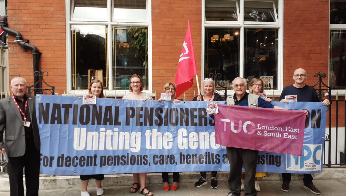 A group of TSSA staff and members holding a huge blue banner that says "National Pensioners Convention, Uniting the Generations, For decent pensions, care, benefits, and housing.