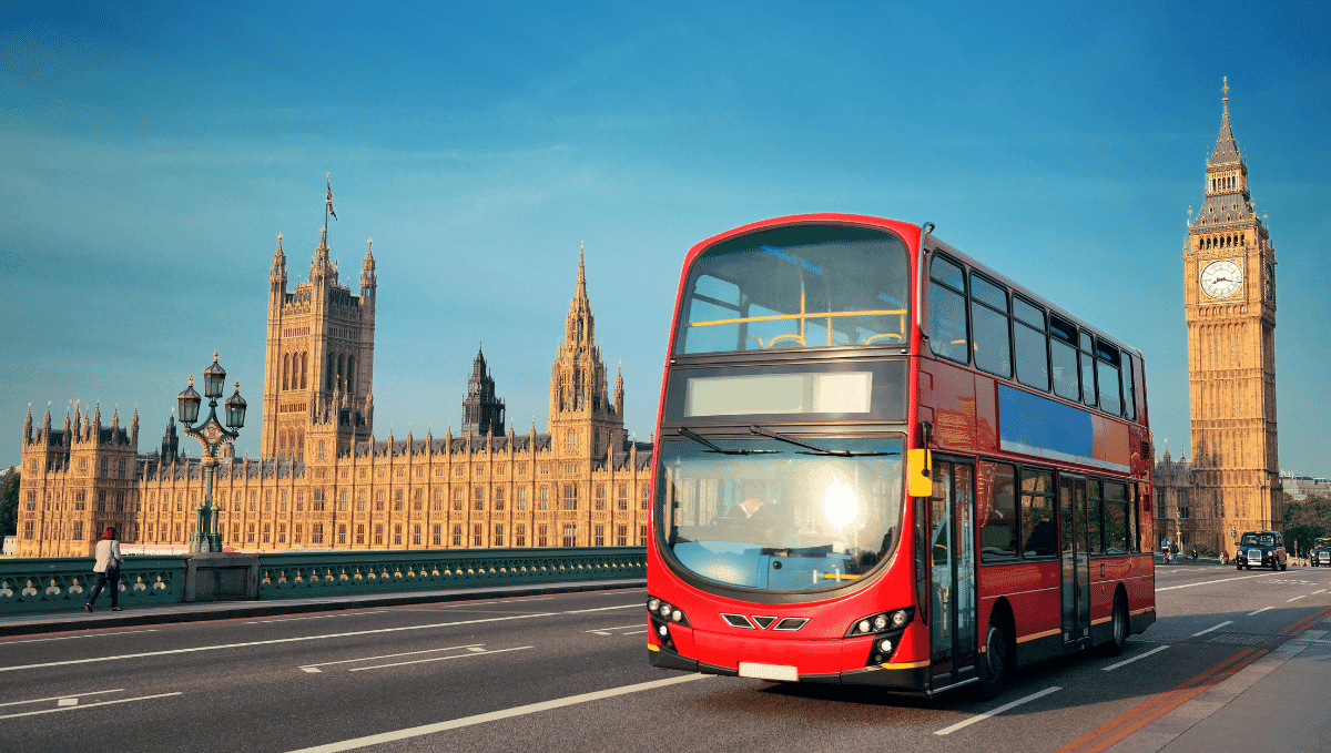 Red double decker London bus in front of parliament