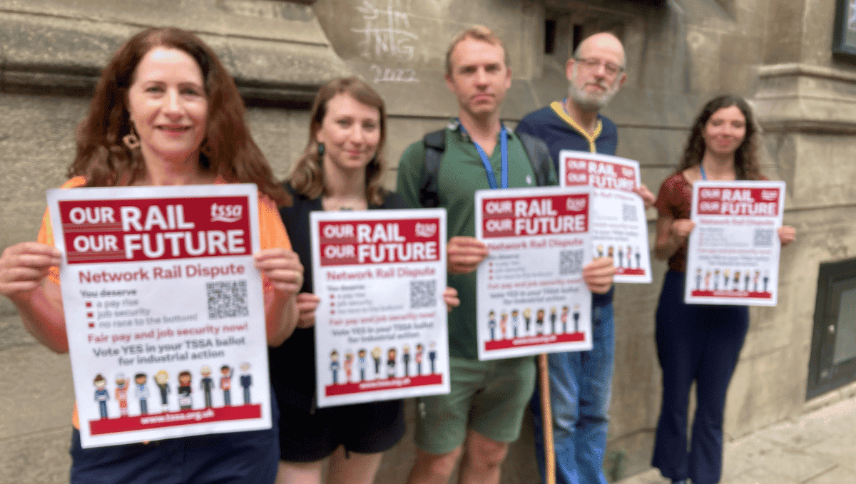 Photo of five Oxford Labour Councillors supporting rail dispute holding up posters