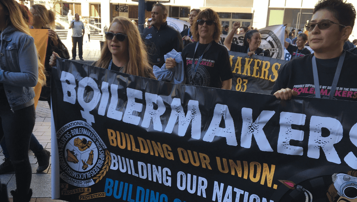 Women Boilermakers on a demonstration holding a banner which says 'building our union'