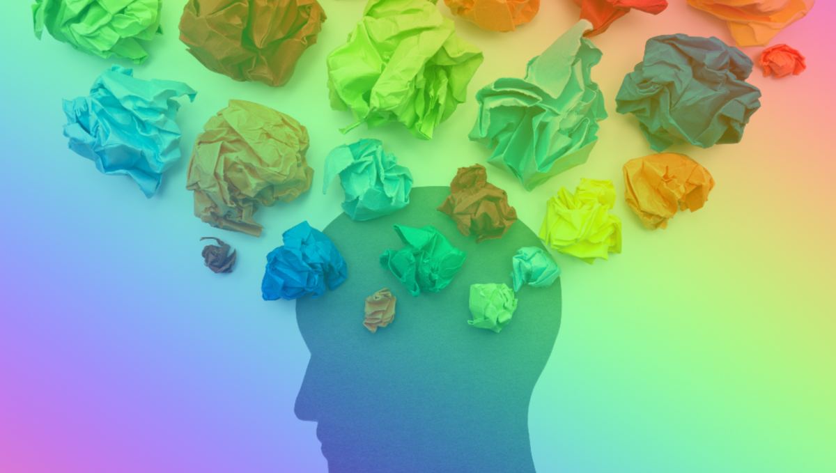 Silhouette of a head, with coloured paper as thoughts bubbles.