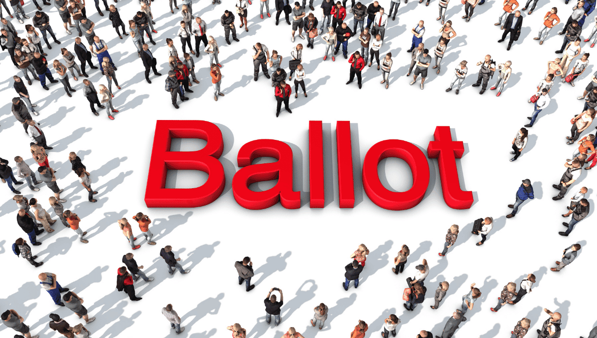 The word 'ballot' written in red with a crowd of people looking at it