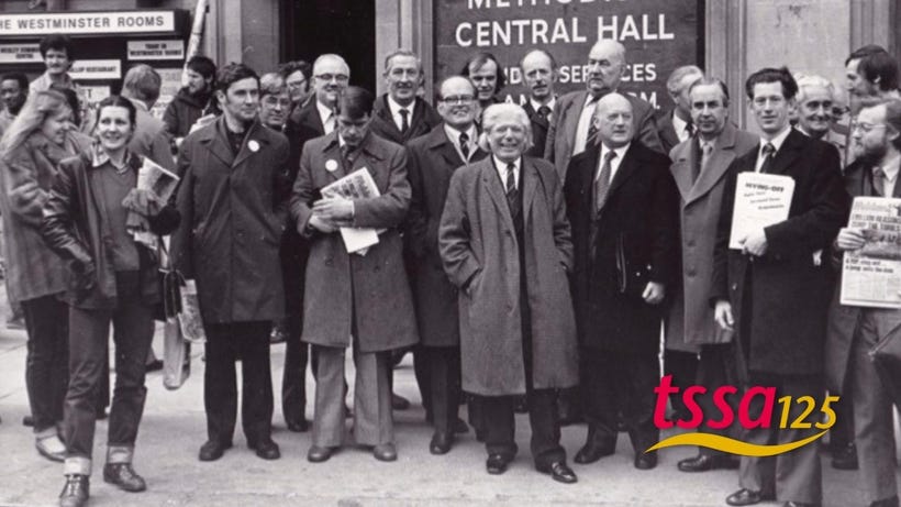Black and white photo showing group who were part of 2000 rail workers lobbying parliament against Transport Bill in 1981 (With TSSA 125 Logo)
