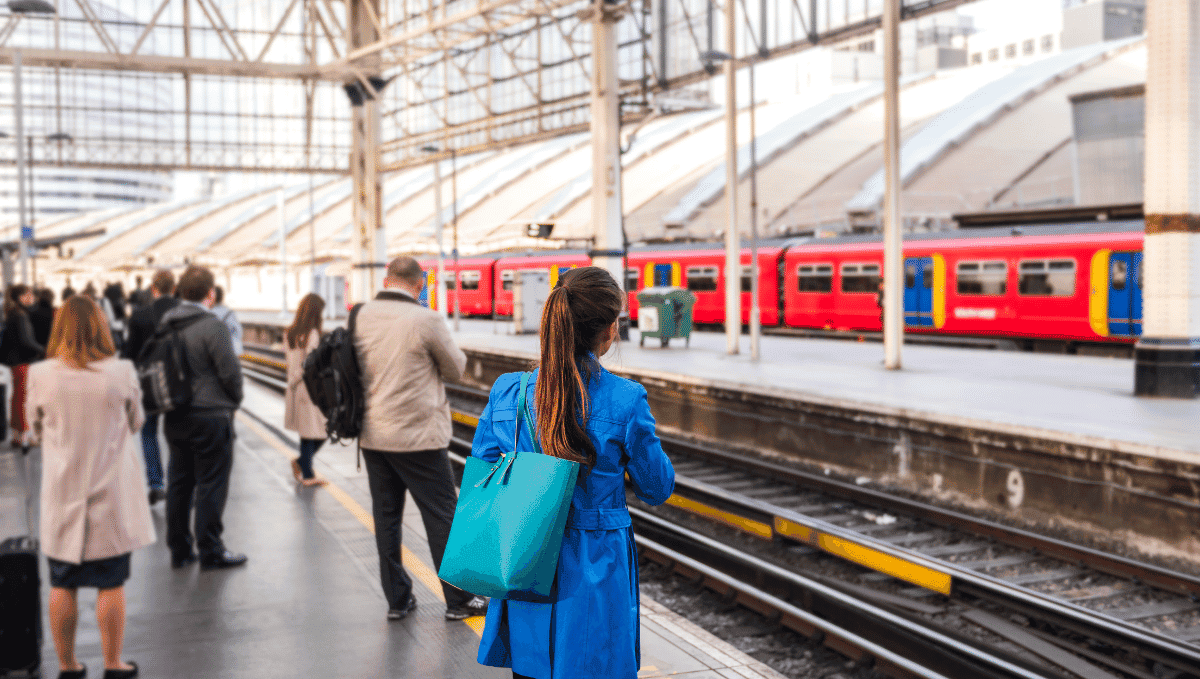 Commuters on platform at Waterloo station waiting for train to arrive