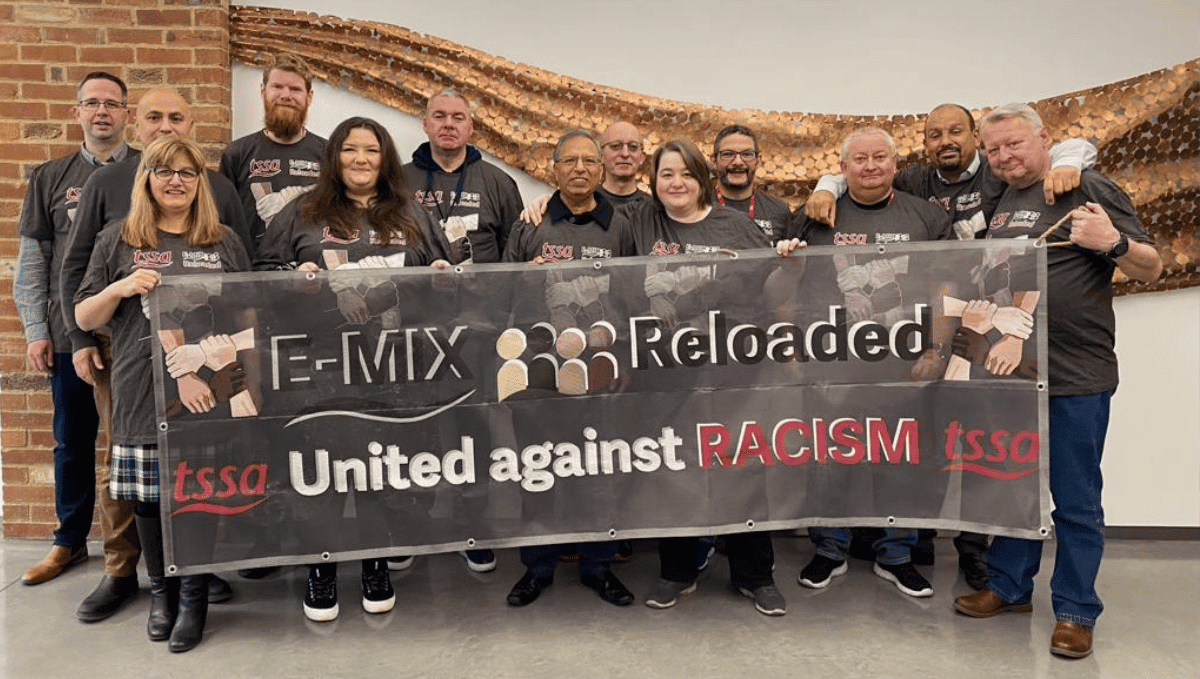 TSSA's Executive Committee holding a huge banner reading E-Mix Reloaded: United against Racism 