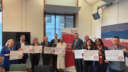 MPs and TSSA activists holding banners saying "Time to end the abuse and harrassment of transport workers." at a launch for TSSA's report on violence against transport workers.