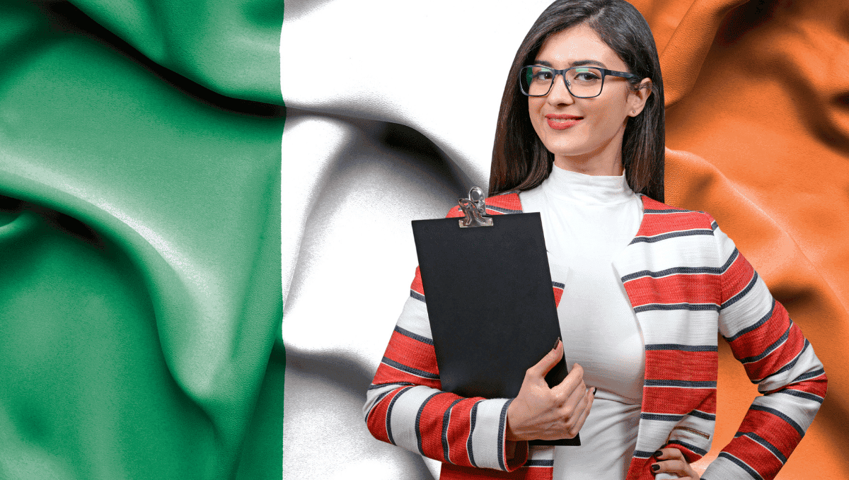 Woman with clipboard standing in front of Irish flag.