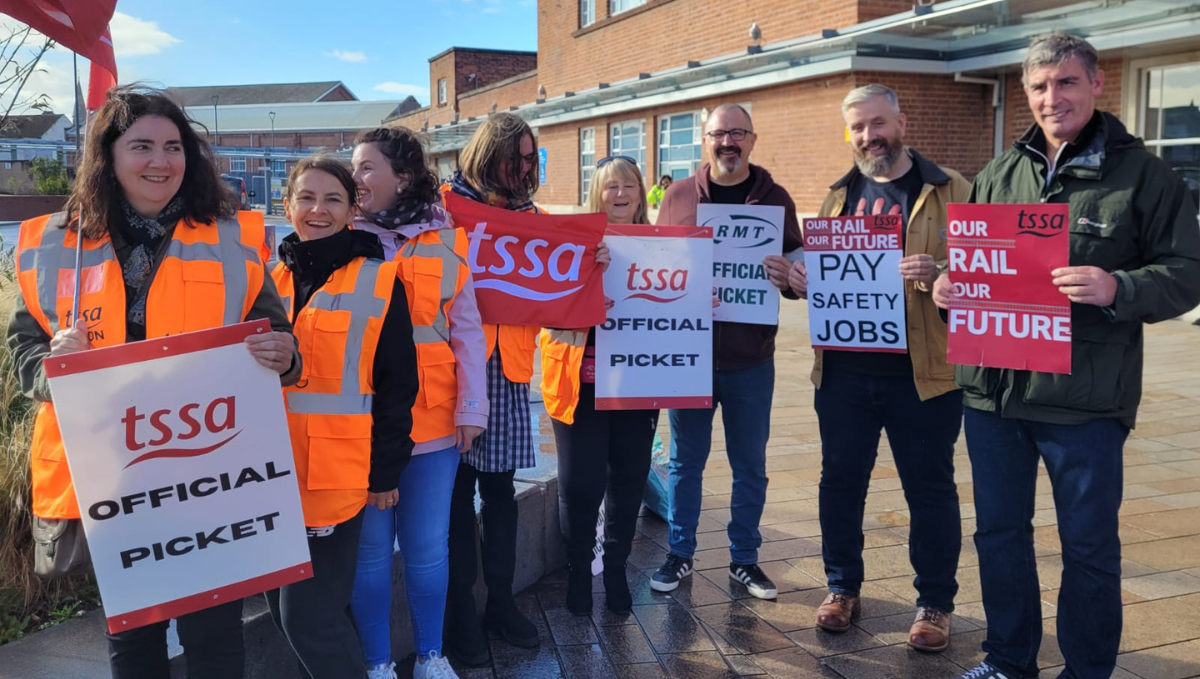 Doncaster picket line people holding TSSA flags, placards and 'official picket' posters 1 October 2022
