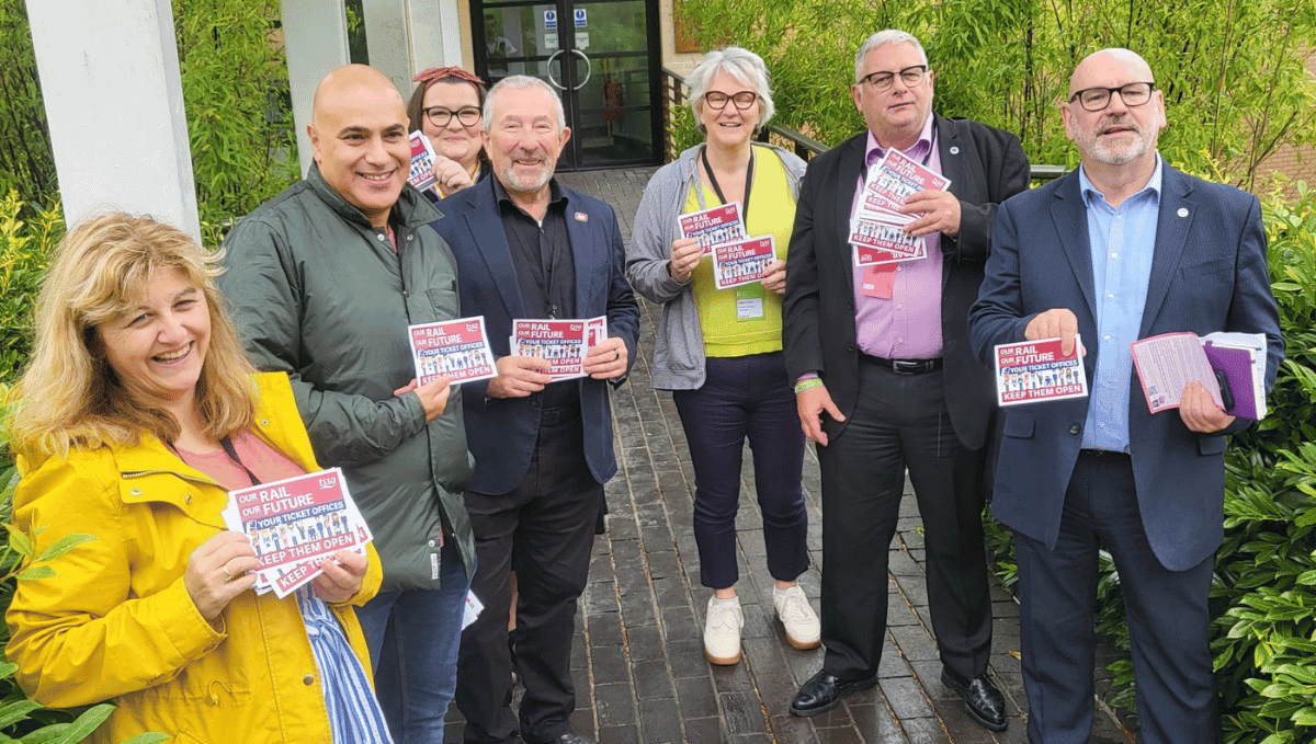 Seven people holding 'Save our ticket offices' leaflets including Labour NEC member Nicola Jukes, former TSSA President Marios Alexandrou, TSSA Executive Committee member Gemma Southgate, Interim General Secretary Peter Pendle, two other ASLEF members and ASLEF General Secretary Mick Whelan 
