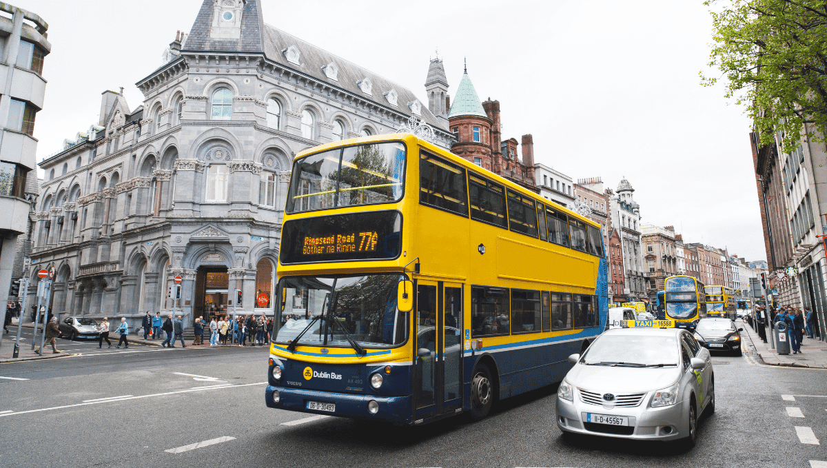 Yellow and blue Dublin Bus on road with other traffic