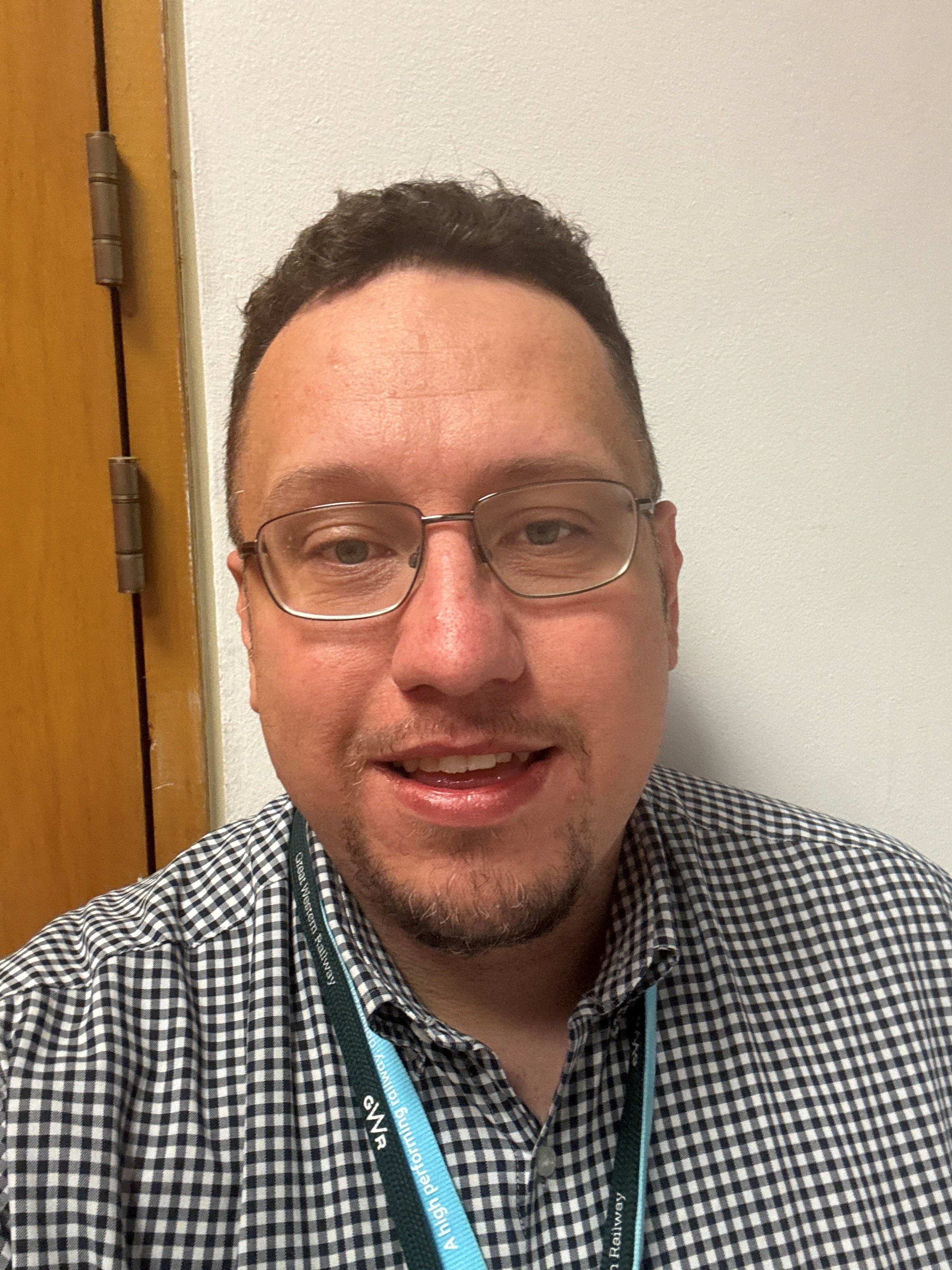 TSSA Rep, Daniel Lane a white man with glasses, brown hair and a check shirt.
