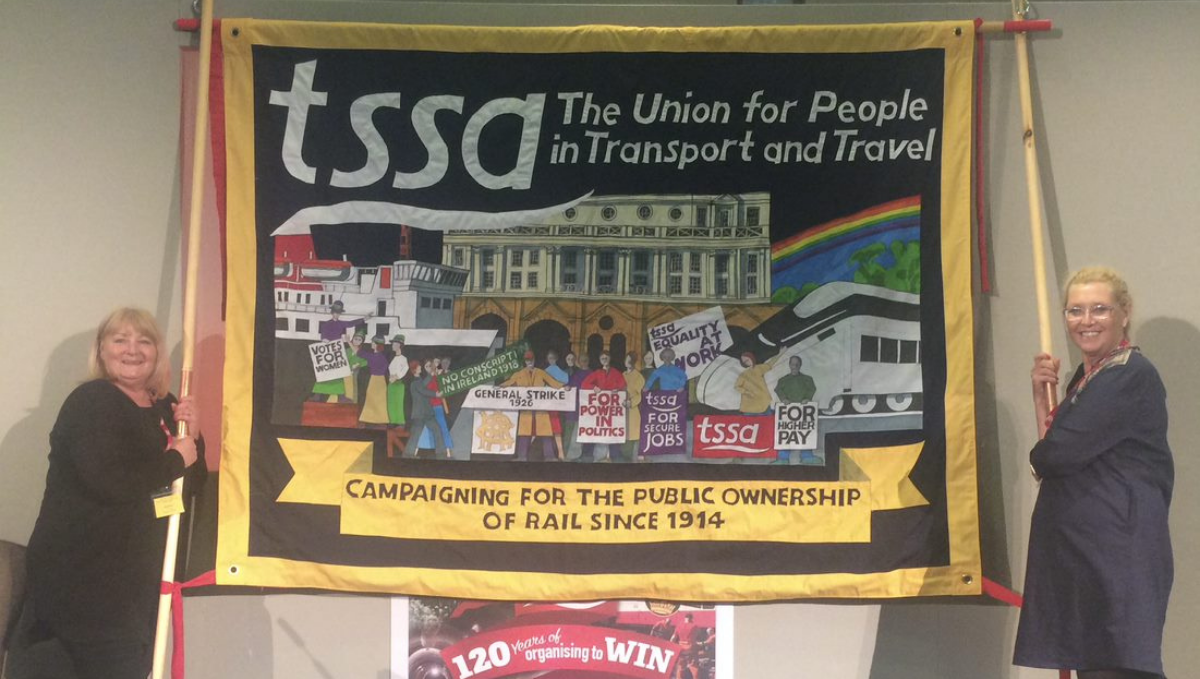 TSSA banner being held by two women