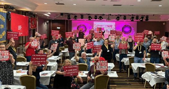 Delegates at TSSA conference holding up signs that read "We demand better!"