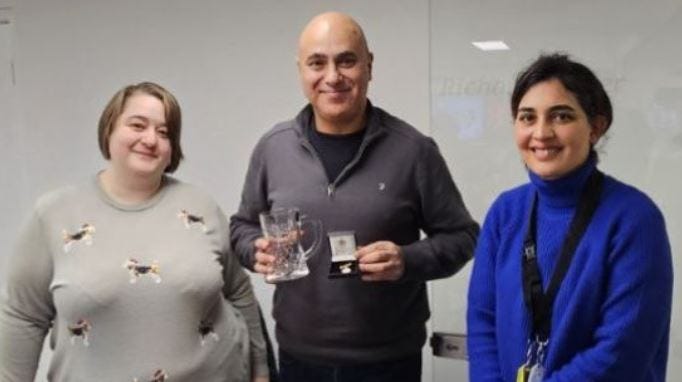 The President Melissa Heywood, and General Secretary, Maryam Eslamdoust, present the former Interim President - Marios Alexandrou with a gold medallion and a commemorative glass. 