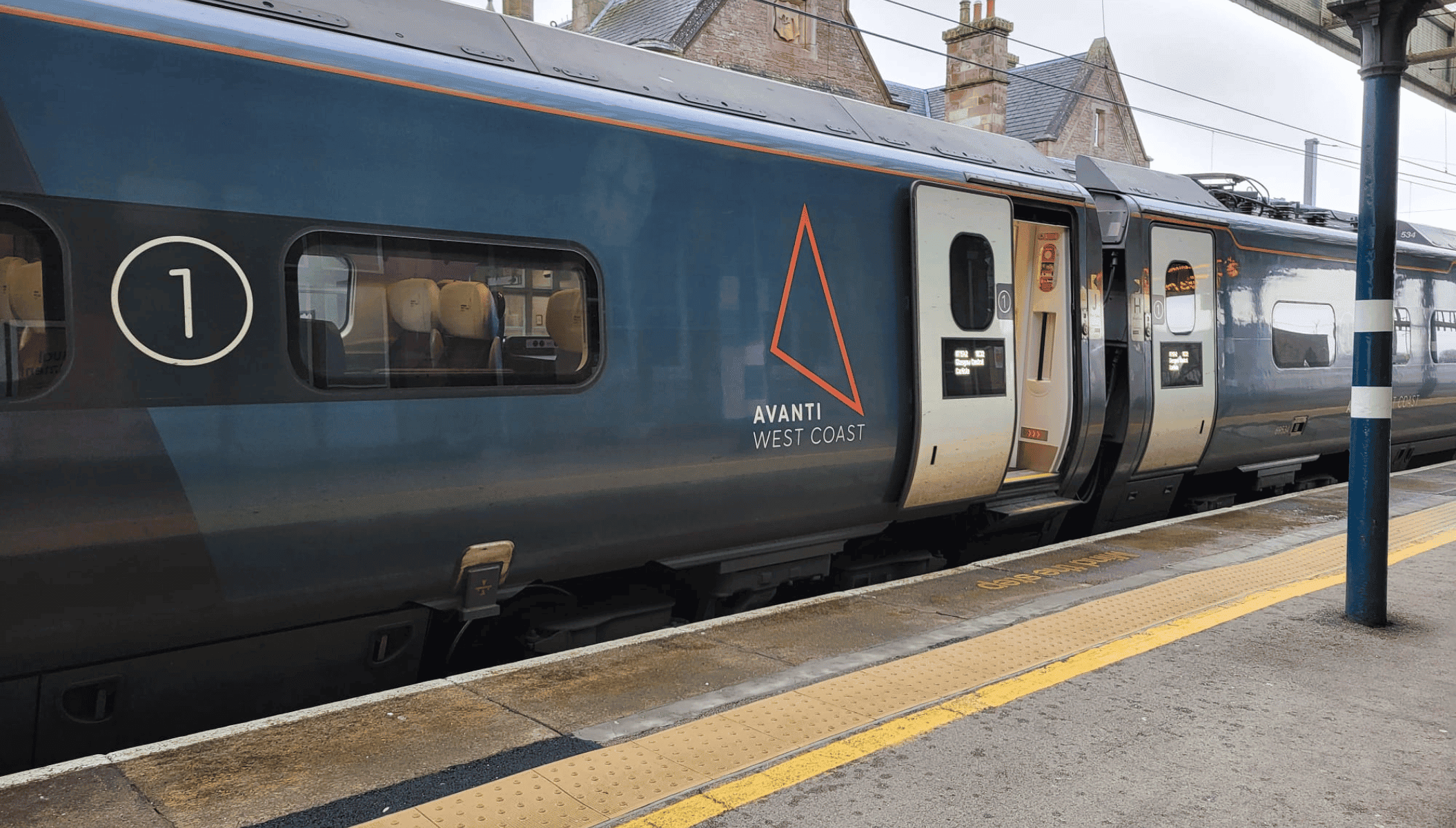 An Avanti West Coast train standing at Penrith station with the doors open.