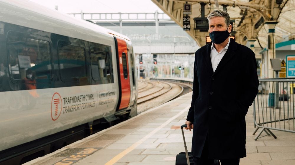 Kier Starmer standing on Cardiff station platform wearing facemask 