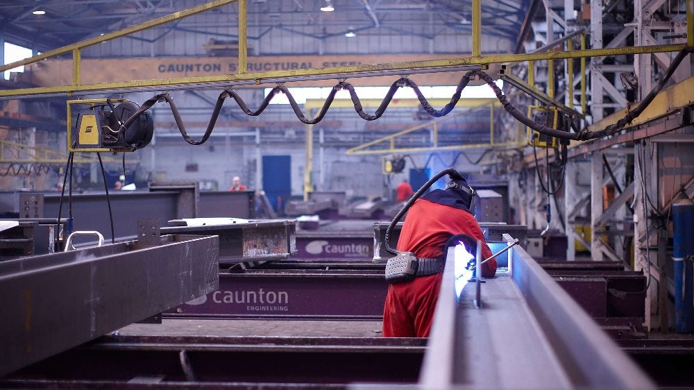 Engineer working steel in Cauton facility.