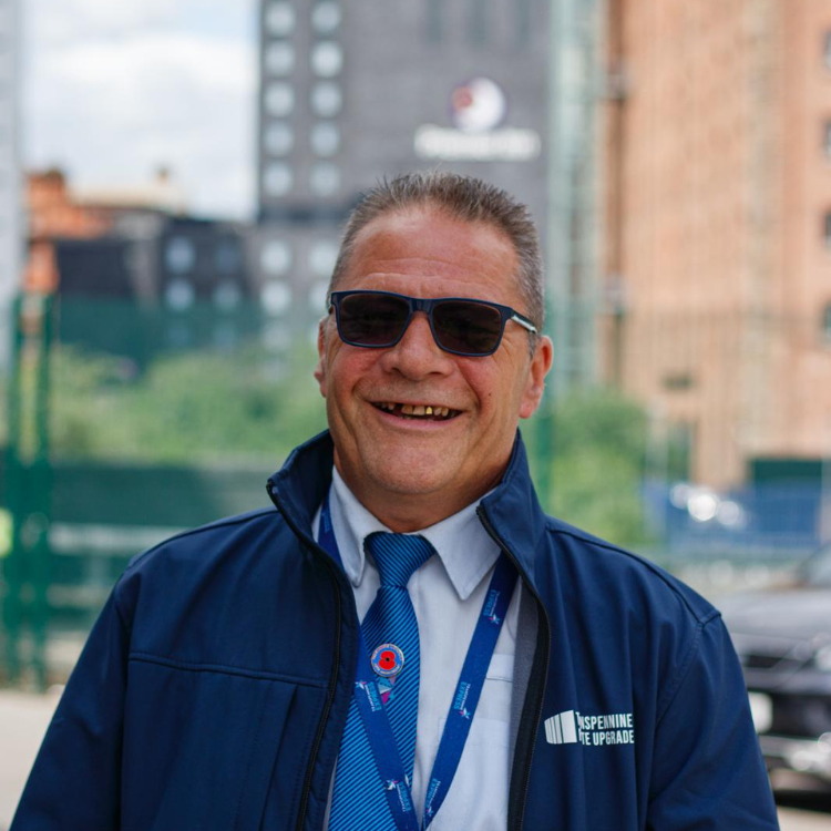 Anthony Moynihan TPE Representative - White man wearing sunglasses and blue coat