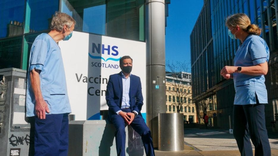 Scottish Labour Leader Anas Sarwar talking to man and woman in NHS uniforms