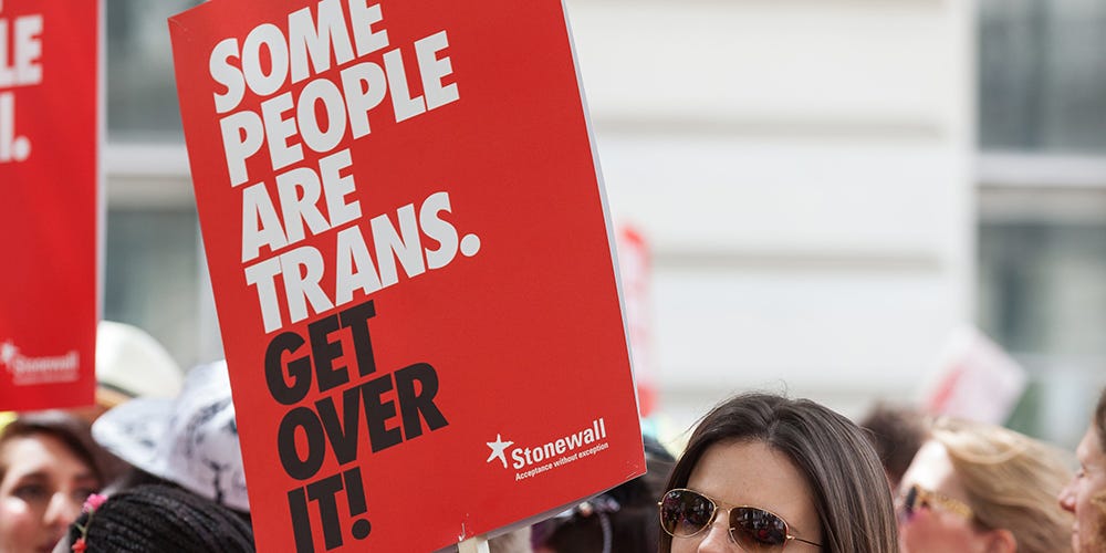 Stonewall© "Some people are trans" sign being held